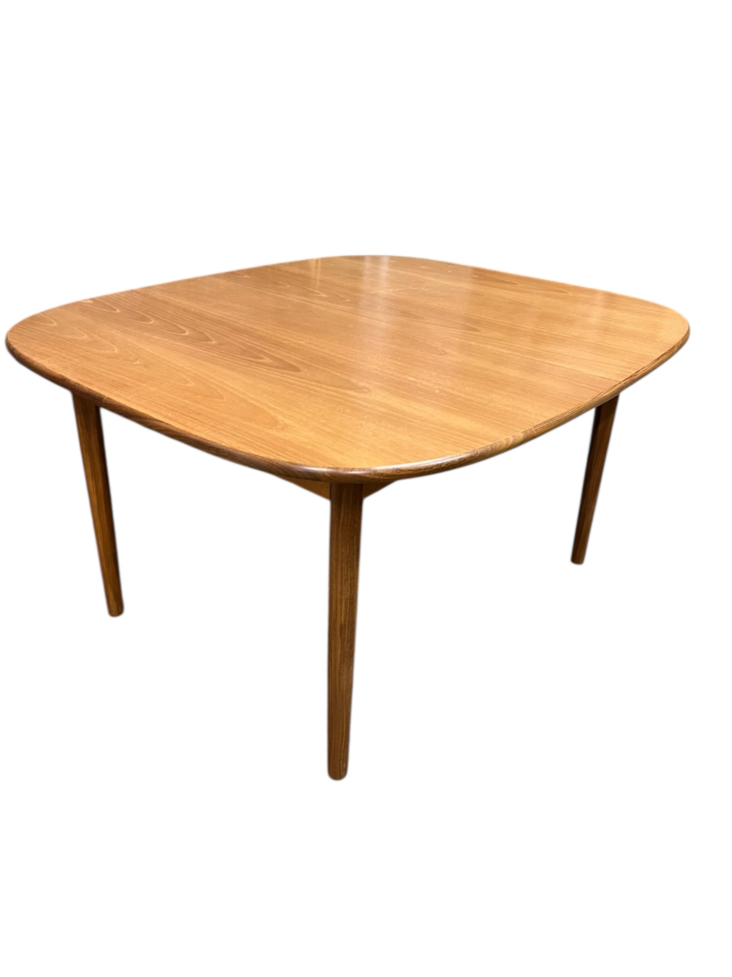 A mid century G Plan Fresco teak dining suite comprising dining table 184cm extended, depth 116cm, height 73cm, six chairs, two with arms and a four door sideboard, width 152cm